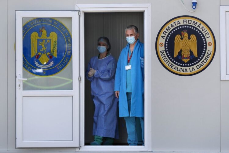 epa09149745 Romanian military medical personnel wait for locals to be vaccinated at the mobile vaccination center installed in the yard of the public school of Afumati village, near Bucharest, Romania, 21 April 2020. Starting from 21 April, the Romanian Army launched 20 new mobile vaccination centers against COVID-19 throughout the country, in order to speed-up the vaccination campaign in isolated or hard to reach localities. Mobile vaccination centers are serviced by military medical personnel, and assisted by civilian paramedics. Romanian authorities hope to reach 100,000 vaccinations a day.  EPA/ROBERT GHEMENT