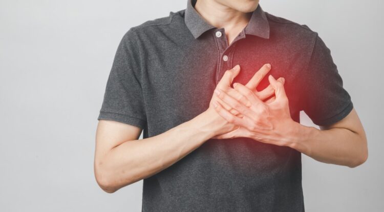 Man has chest pain suffering by heart disease, Cardiovascular disease, heart attack. Health care concept.