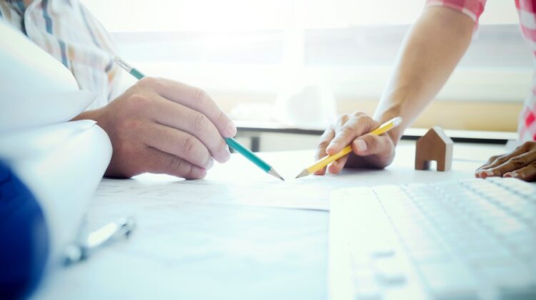 Image of engineer meeting for architectural project. working with partner and engineering tools on workplace vintage tone.